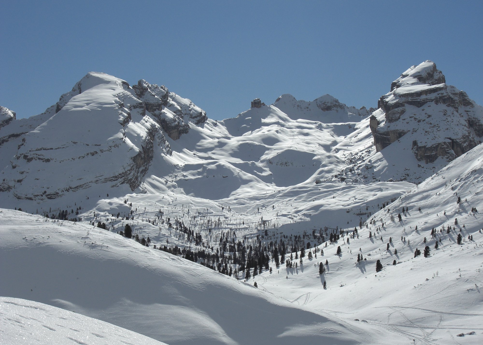 Multi-day ski touring group crossing a Dolomites ridge